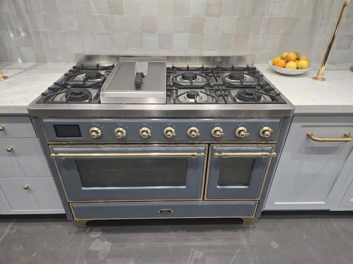 Freestanding gas range with dual ovens and brass hardware